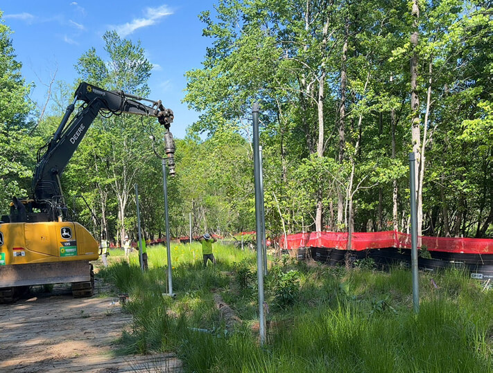 setting up helical piers near Greenway Trail